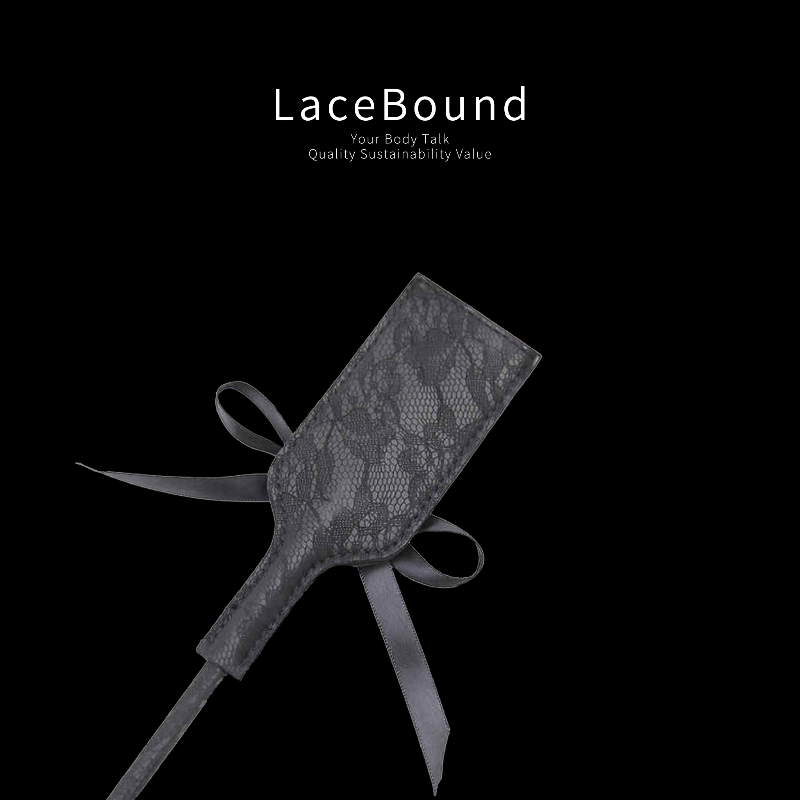 Black feather tickler with soft plume and leather paddle set for sensual BDSM play, combining gentle teasing with firm touch in erotic foreplay.