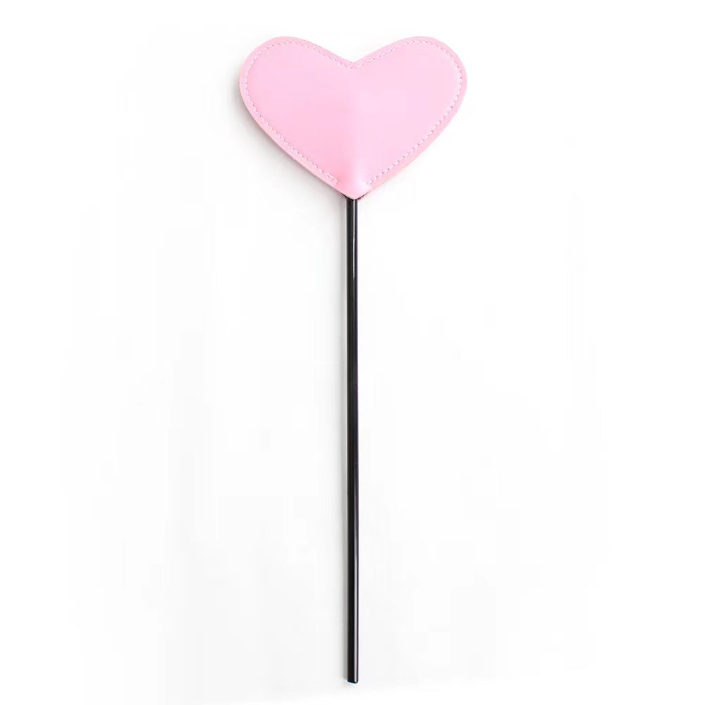 Heart-shaped BDSM whip playful spanking toy, featuring a soft faux leather heart tip and sturdy handle, ideal for gentle teasing and playful impact play.