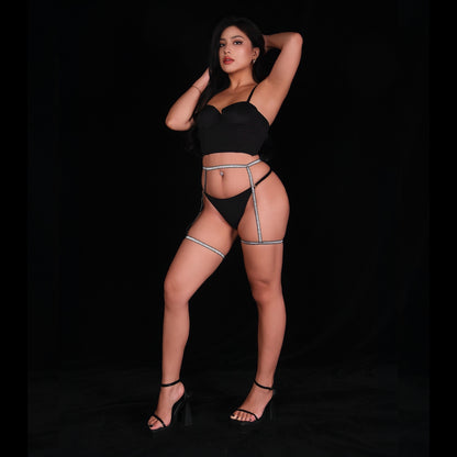 Sexy black satin lingerie set with smooth, glossy finish, featuring an elegant bra with adjustable straps and a matching thong, designed for a refined and seductive silhouette.